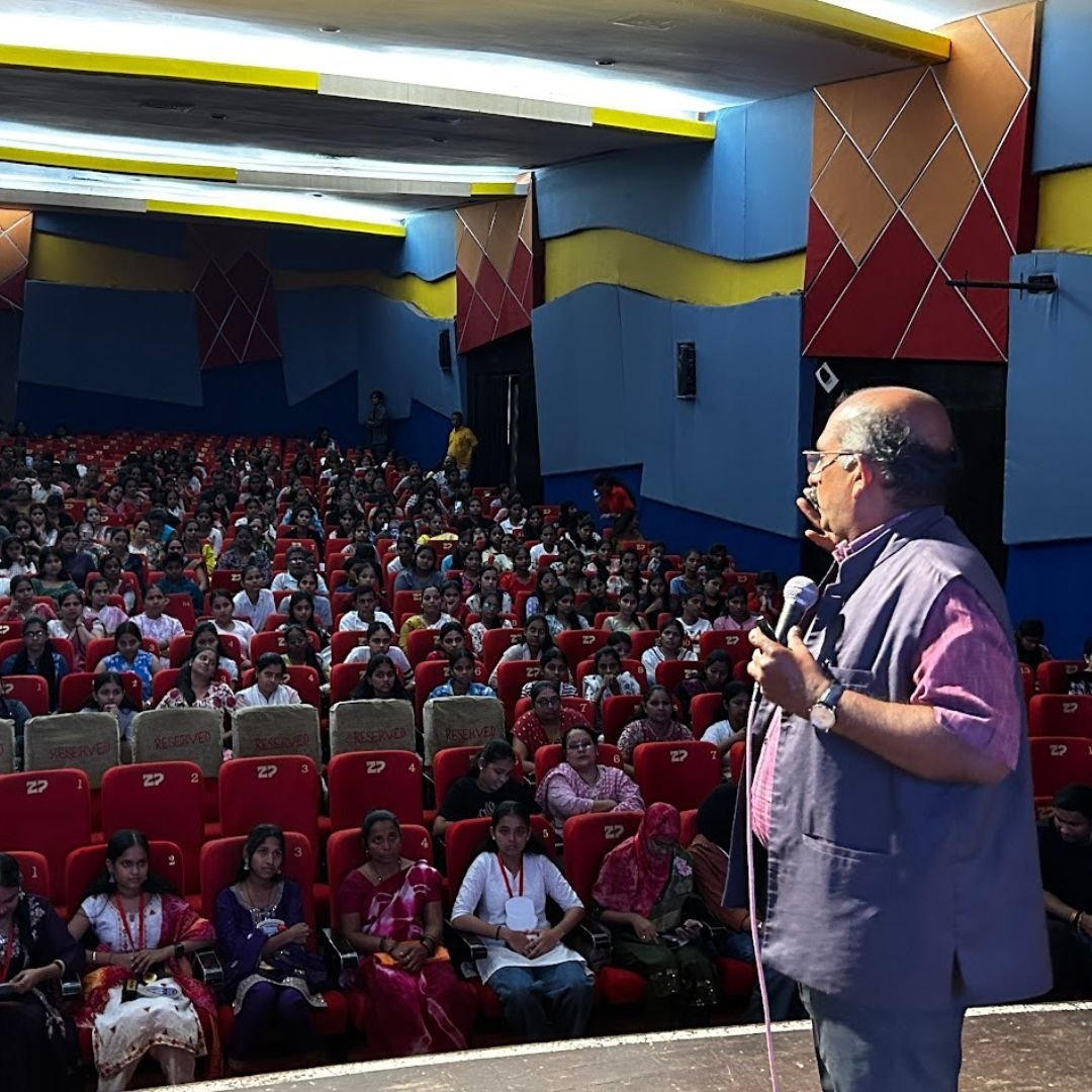 Prajesh Trotsky speaking on stage to a packed hall